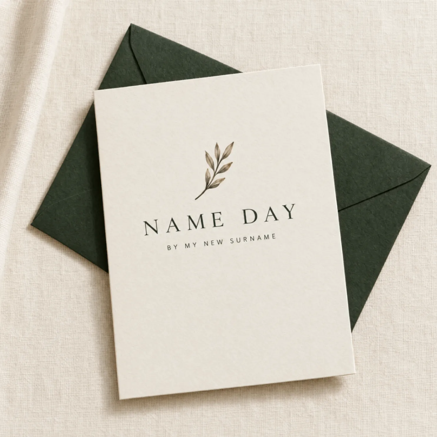 Name Day ivory card with a leaf mark on a forest green envelope over natural linen