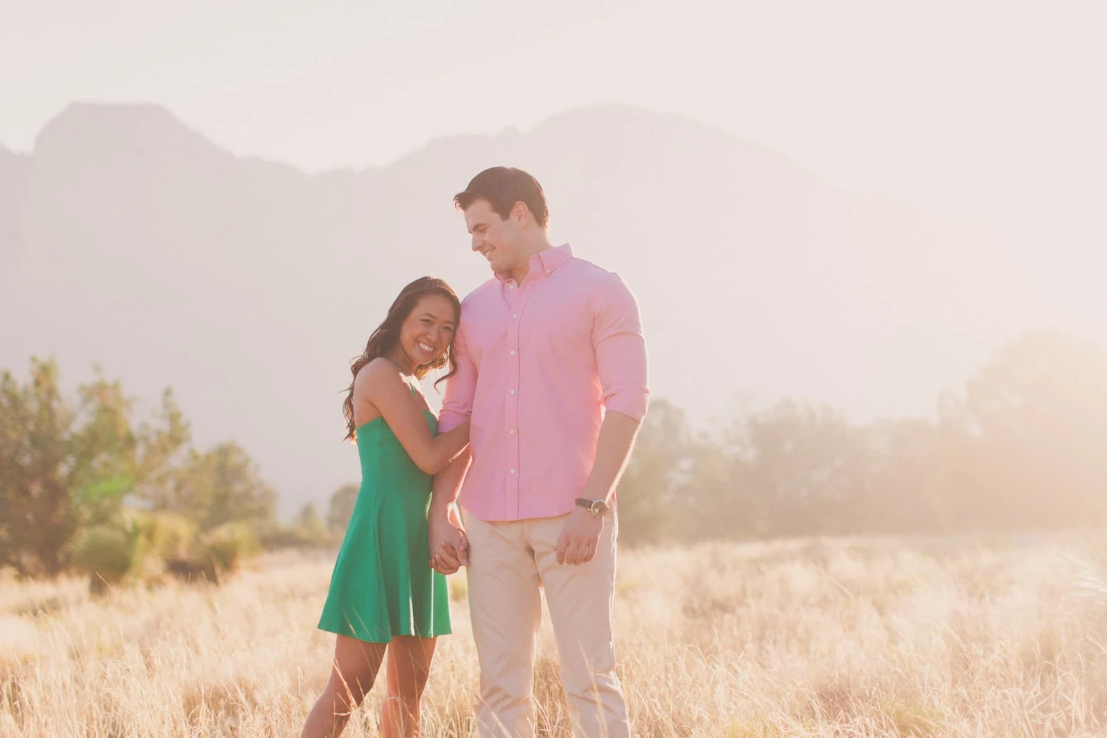 Tiffanie and Brandon holding hands in warm mountain light