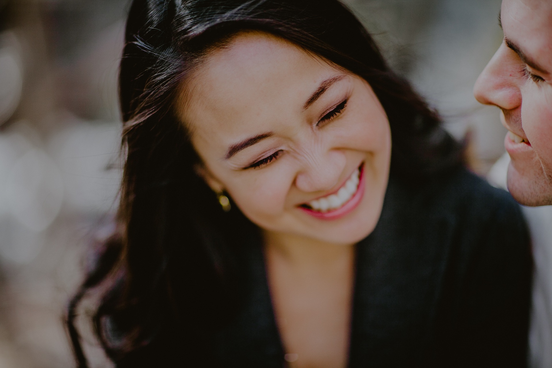 Brandon and Tiffanie laughing during their engagement photographs.