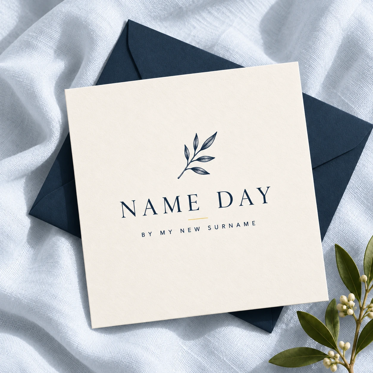Name Day card and navy envelope on pale blue linen, with a small botanical sprig